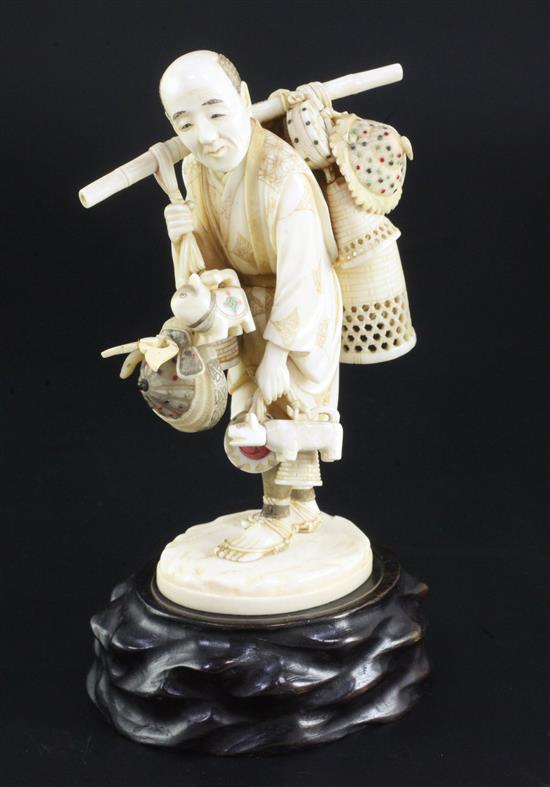 A Japanese ivory okimono of a basket seller, early 20th century, 14.5cm, wood stand